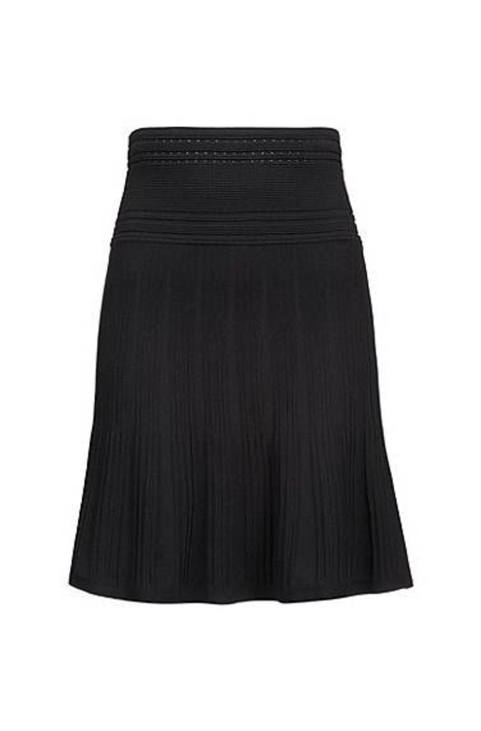 Mixed-structure knitted skirt with adaptable waistband