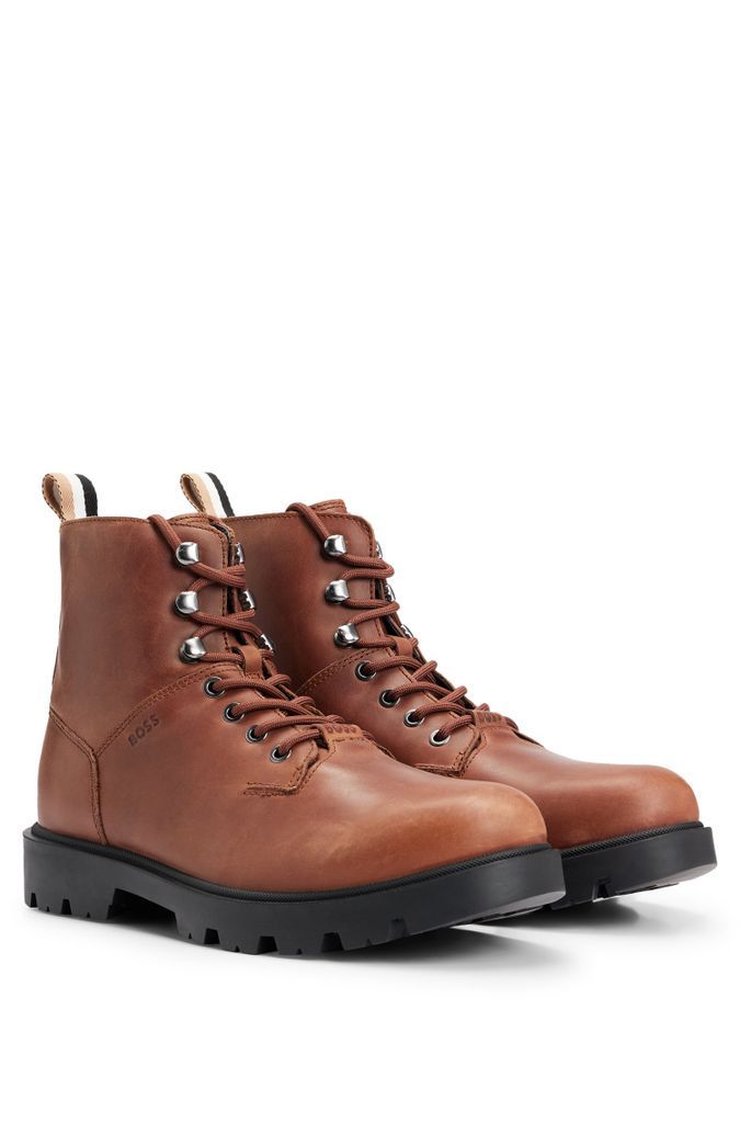 Half boots in pull-up leather with embossed logo